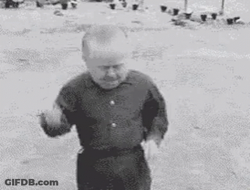 A Black And White Photo Of A Small Man Dancing . GIF