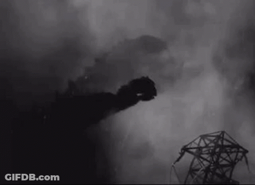 A Black And White Photo Of A Smoke Coming Out Of A Building . GIF