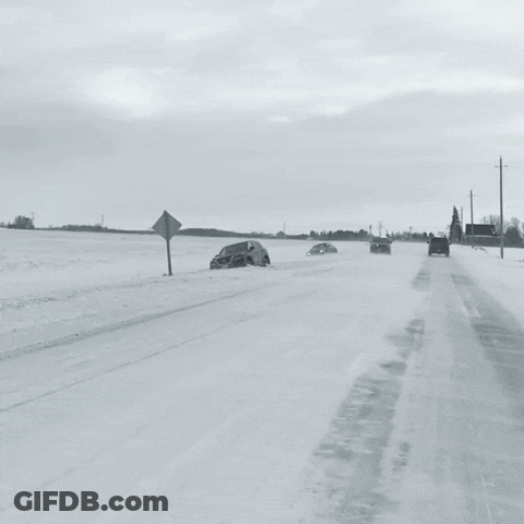 A Black And White Photo Of A Snowy Road With A Police Car In The Background GIF