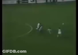 A Black And White Photo Of A Soccer Game With A Goalie In The Background . GIF