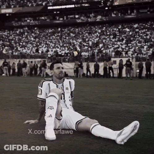 A Black And White Photo Of A Soccer Player With The X.com Watermark GIF