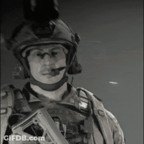 Black And White Photo Of Soldier With Helmet And Gun GIF