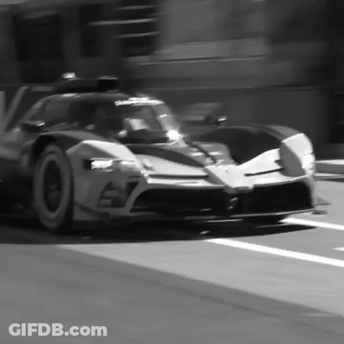 A Black And White Photo Of A Sports Car With The Number 57 On It GIF