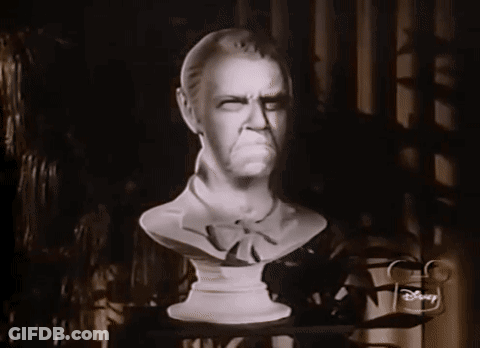 A Black And White Photo Of A Statue Of A Man With A Disney Logo On The Corner GIF