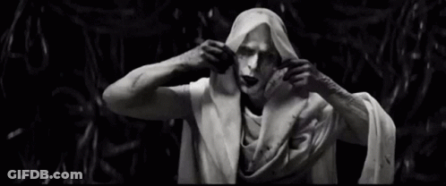 A Black And White Photo Of A Statue Of A Man Wrapped In A Cloth . GIF