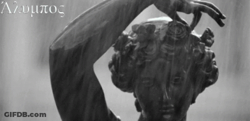 A Black And White Photo Of A Statue Of A Woman With The Letters A And U On The Bottom Right GIF