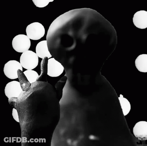 A Black And White Photo Of A Statue With A Thumbs Up GIF