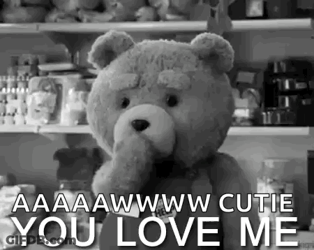 A Black And White Photo Of A Teddy Bear With The Words `` You Love Me '' Written Below It . GIF