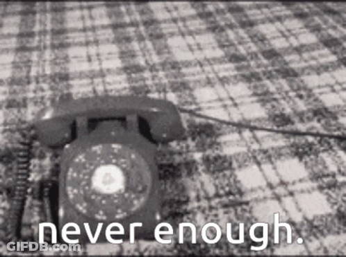 A Black And White Photo Of A Telephone On A Checkered Blanket With The Words Never Enough Written Below It . GIF