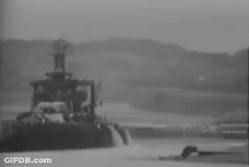 A Black And White Photo Of A Tug Boat In The Water . GIF