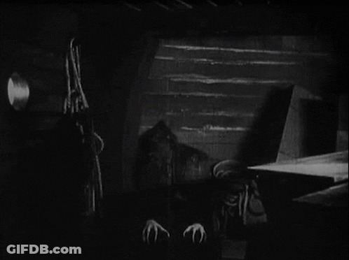 A Black And White Photo Of A Vampire With Sharp Claws . GIF