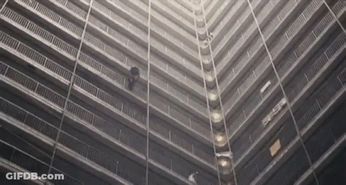 A Black And White Photo Of A Very Tall Building With The Letters Eee On The Side GIF