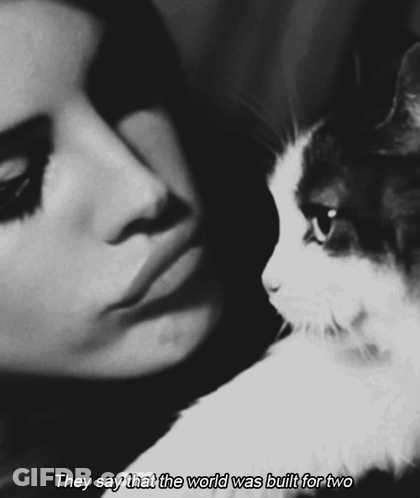 A Black And White Photo Of A Woman And A Cat With The Words They Say That The World Was Built For Two On The Bottom GIF