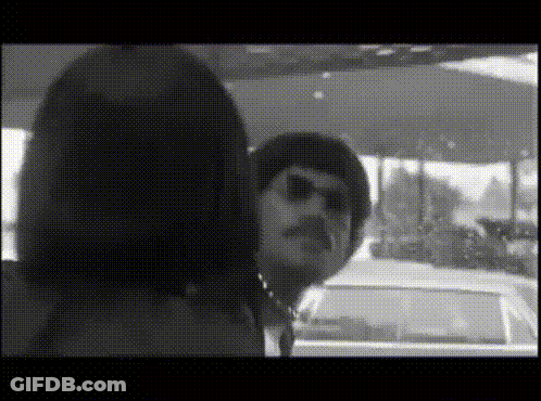A Black And White Photo Of A Woman And A Man GIF