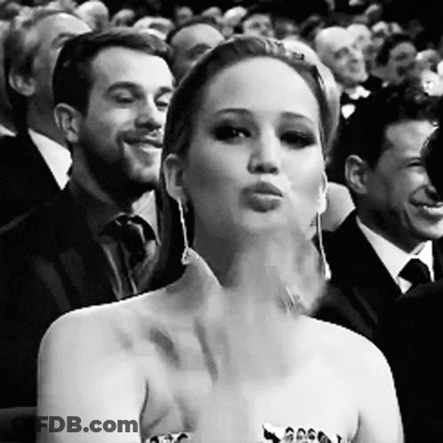 Black And White Woman Blowing Kiss In Crowd GIF