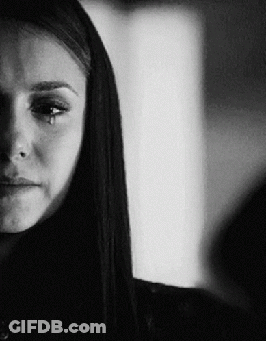 A Black And White Photo Of A Woman Crying With A Tear Running Down Her Face . GIF