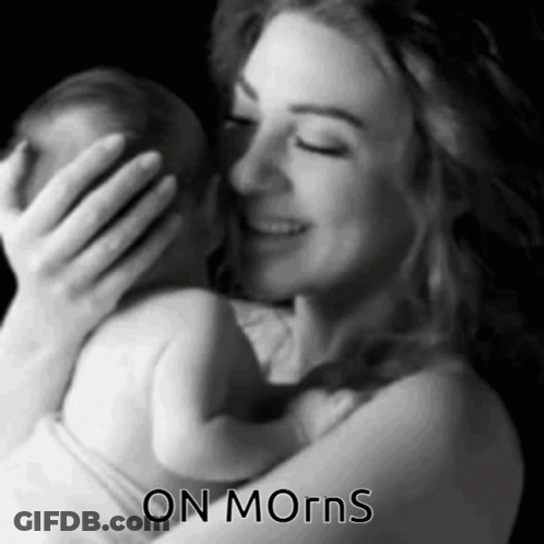 A Black And White Photo Of A Woman Holding A Baby With The Words " On Morns " Below Her GIF
