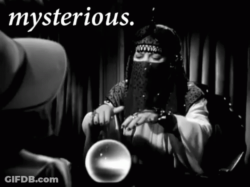 A Black And White Photo Of A Woman Holding A Crystal Ball With The Word Mysterious Written Above Her GIF