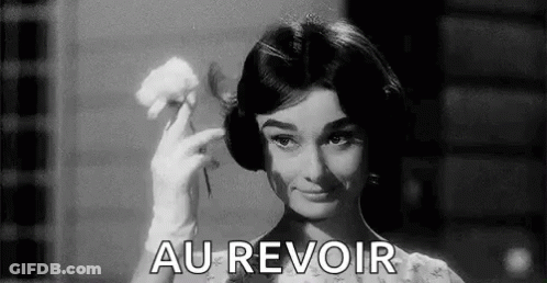 A Black And White Photo Of A Woman Holding A Flower And The Words `` Au Revoir '' . GIF