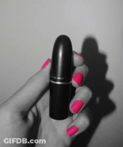 A Black And White Photo Of A Woman Holding A Lipstick GIF