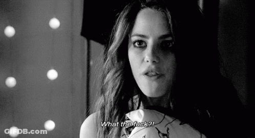 A Black And White Photo Of A Woman Holding A Pillow And Asking What The Fuck ? GIF