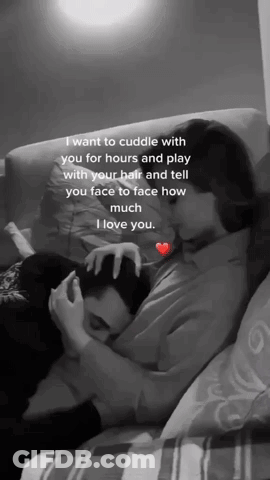 A Black And White Photo Of A Woman Hugging A Man On A Couch .. GIF