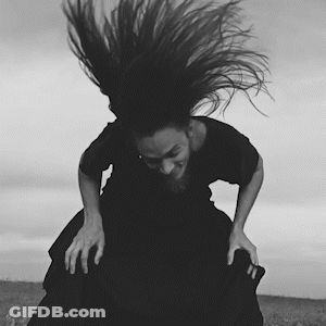 A Black And White Photo Of A Woman In A Black Dress GIF