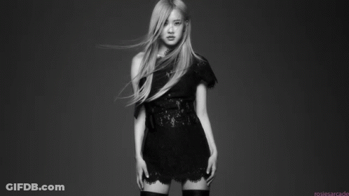A Black And White Photo Of A Woman In A Black Dress And Thigh High Stockings . GIF