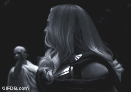 A Black And White Photo Of A Woman In A Costume GIF