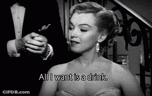 A Black And White Photo Of A Woman In A Dress Saying `` All I Want Is A Drink '' . GIF