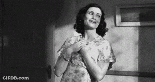 A Black And White Photo Of A Woman In A Floral Dress . GIF