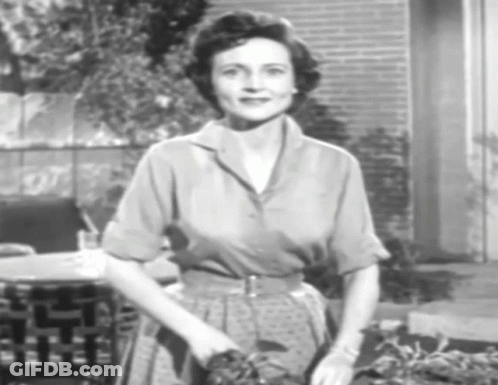 A Black And White Photo Of A Woman In A Polka Dot Dress GIF