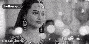 A Black And White Photo Of A Woman In A Traditional Indian Dress . GIF