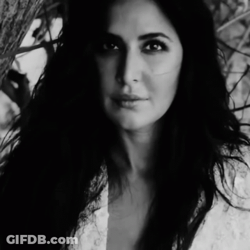 A Black And White Photo Of A Woman In A White Dress GIF