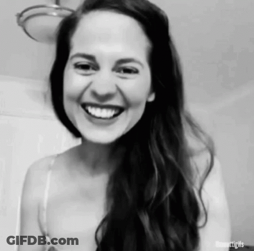 A Black And White Photo Of A Woman Laughing . GIF