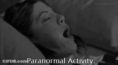 A Black And White Photo Of A Woman Laying In Bed With Her Mouth Open And The Words `` Paranormal Activity '' Below Her . GIF