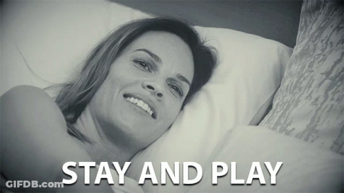 A Black And White Photo Of A Woman Laying On A Bed With The Caption Stay And Play GIF