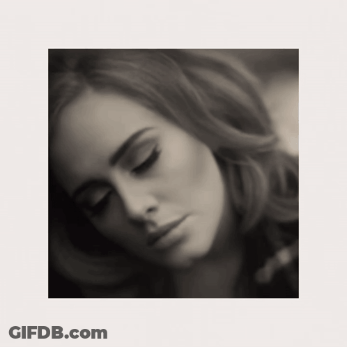 A Black And White Photo Of A Woman Looking Down GIF