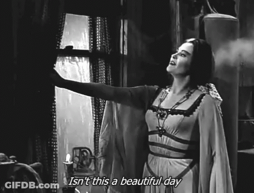 A Black And White Photo Of A Woman Looking Out A Window With The Caption Isn 'T This A Beautiful Day . GIF