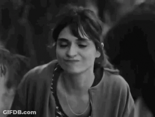 A Black And White Photo Of A Woman Making A Funny Face And Giving A Thumbs Up . GIF