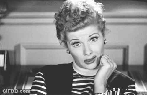A Black And White Photo Of A Woman Making A Funny Face With Her Hand On Her Chin . GIF