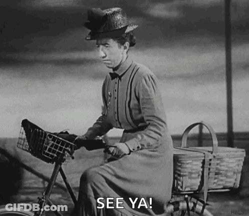 A Black And White Photo Of A Woman Riding A Bicycle With A Basket And The Words `` See Ya '' . GIF