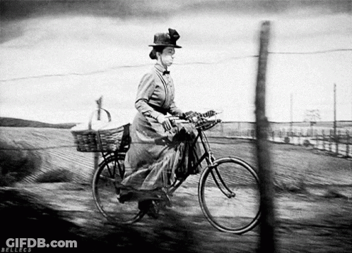 A Black And White Photo Of A Woman Riding A Bicycle With Bellecs Written On The Bottom GIF