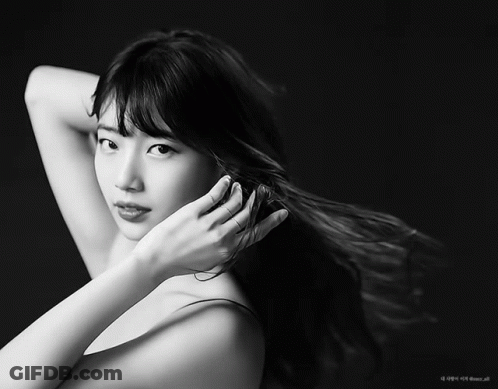 A Black And White Photo Of A Woman 'S Face And Hair GIF