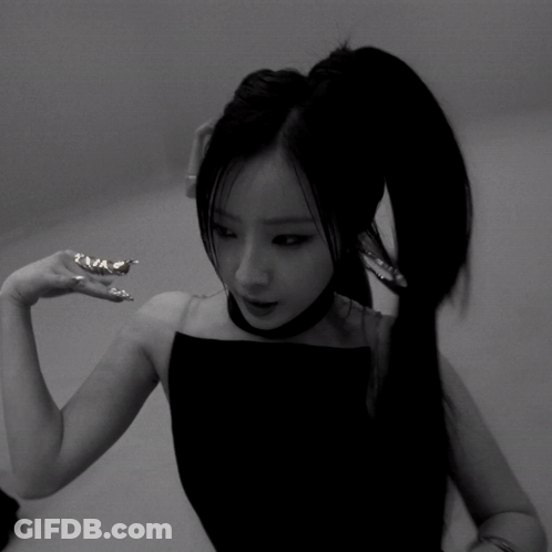 A Black And White Photo Of A Woman 'S Face And Hands GIF