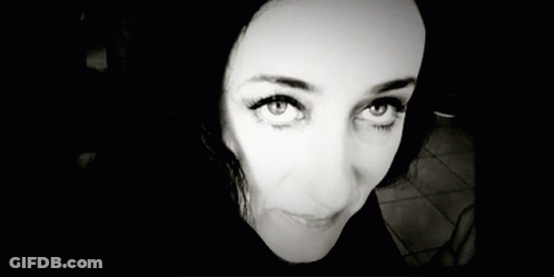 A Black And White Photo Of A Woman 'S Face Smiling GIF