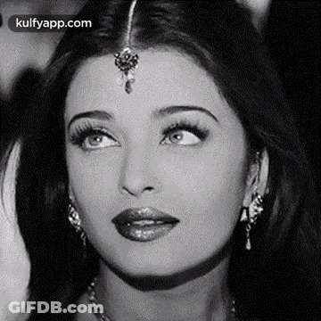 A Black And White Photo Of A Woman 'S Face With A Bindi On Her Forehead . GIF