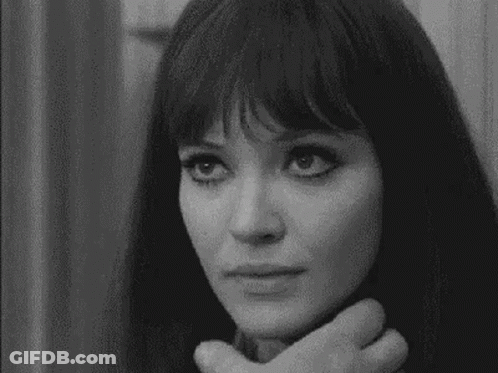 A Black And White Photo Of A Woman 'S Face With A Hand On Her Neck . GIF