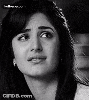 A Black And White Photo Of A Woman 'S Face With A Sad Look On Her Face . GIF