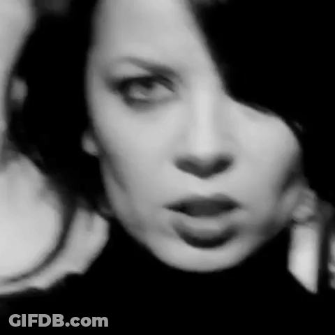 A Black And White Photo Of A Woman 'S Face With A Serious Look On Her Face . GIF
